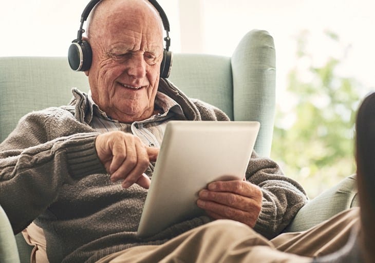 Ældre mand på internet med sin tablet.